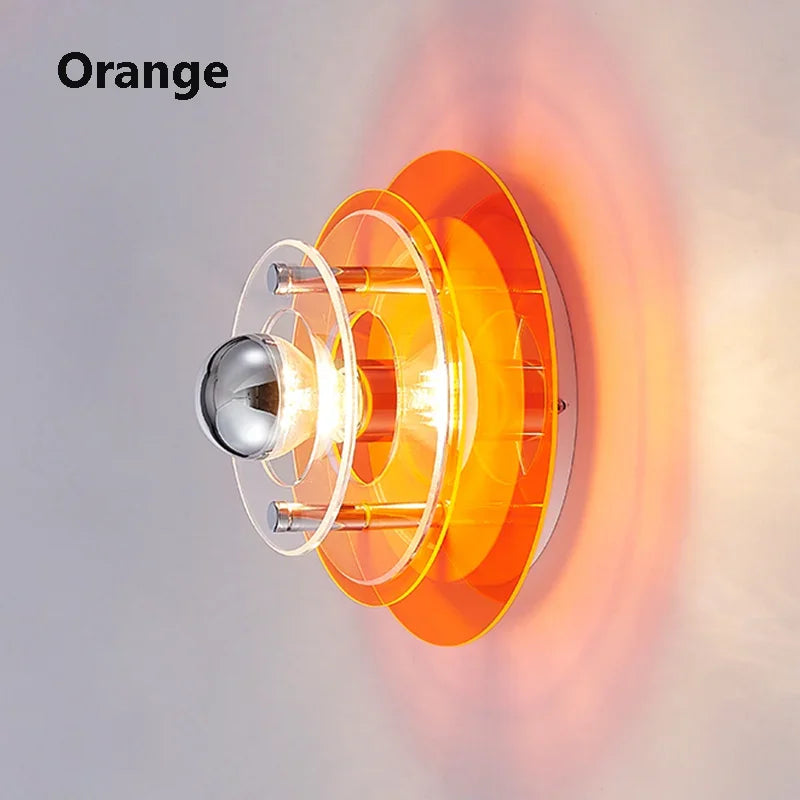 Wall light fixture with orange accents on a gray background