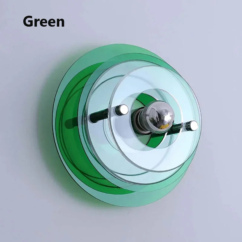Green wall-mounted light fixture on a plain background